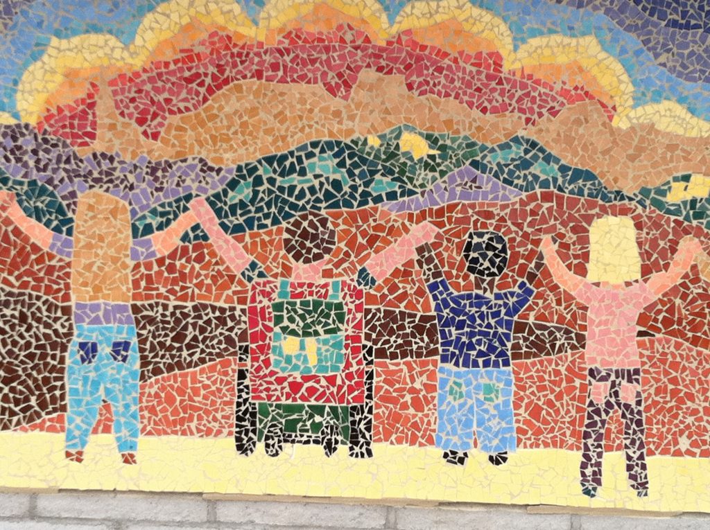 Image of tile mosaic showing children looking at the mountain